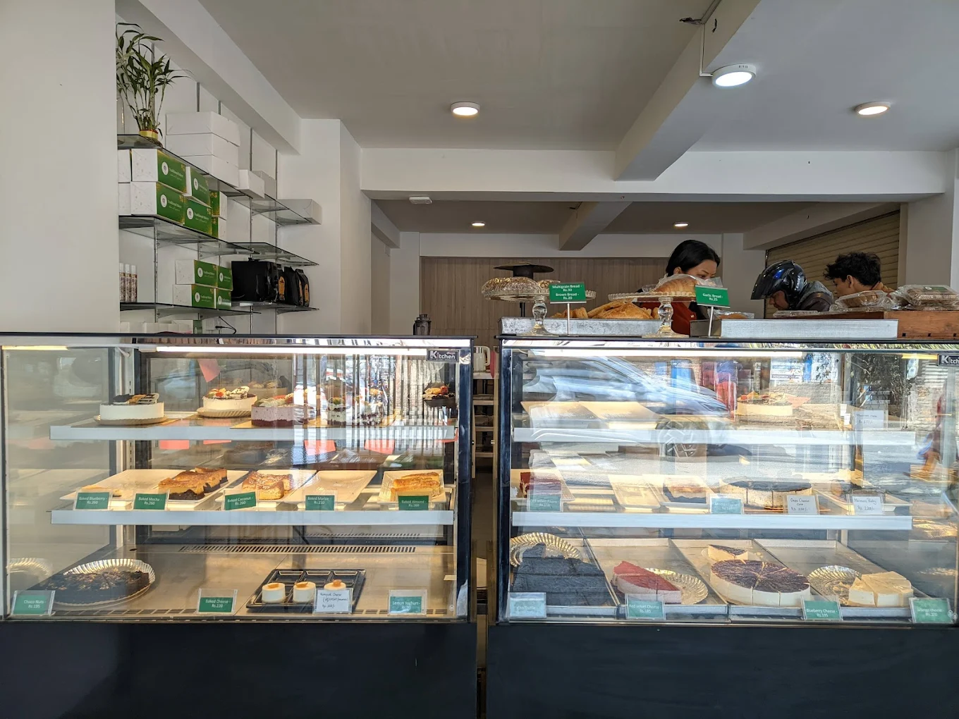 Traditional Bakery interior with pastry display cases and staff behind the counter